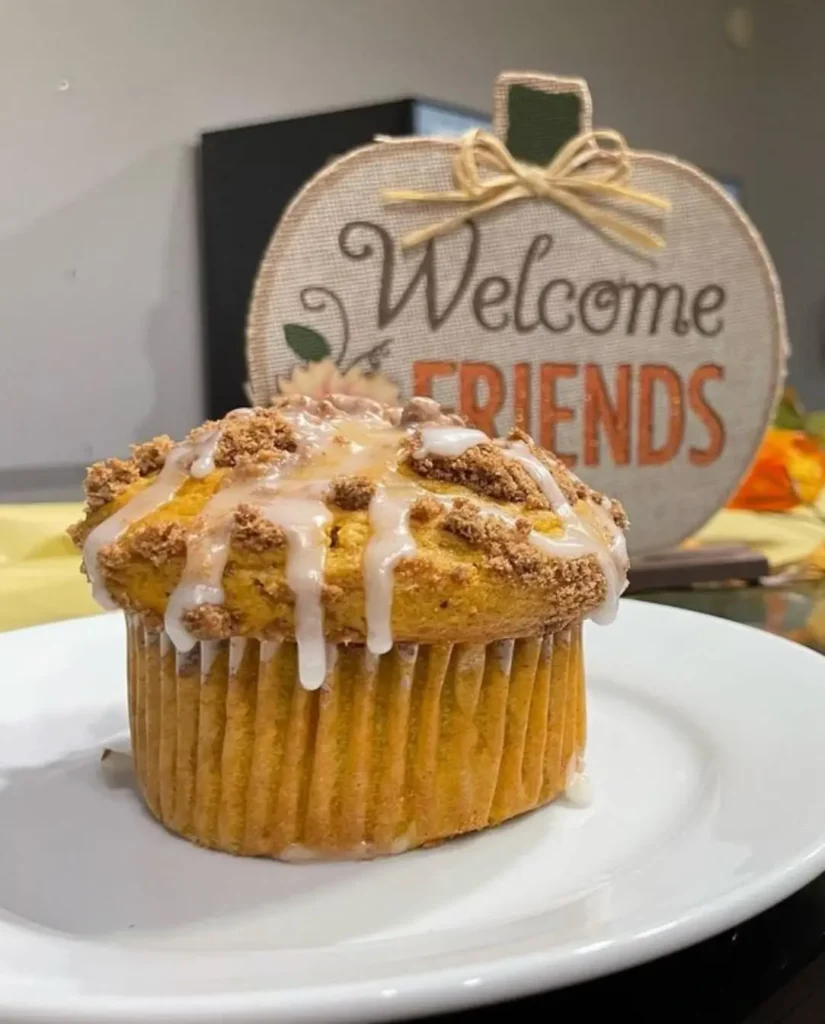 Glazed muffin on plate with 'Welcome Friends' sign