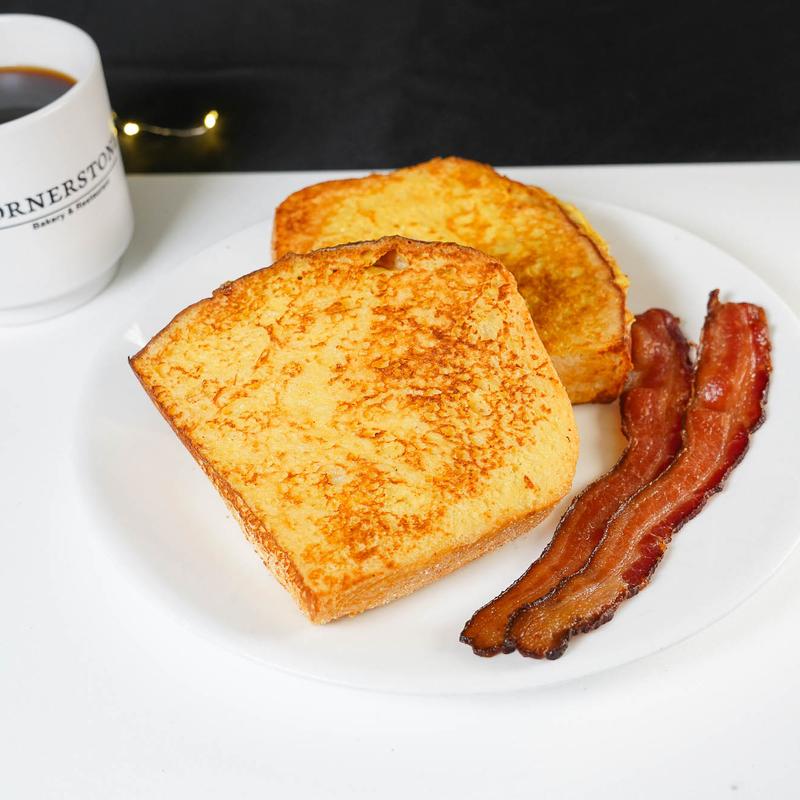 French toast, bacon strips, coffee on table